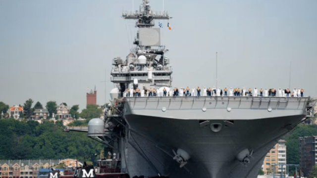 Sailors and military service personnel arrive on the USS Wasp amphibious assault ship on the Hudson River during fleet week, May 24, 2023, in New York.